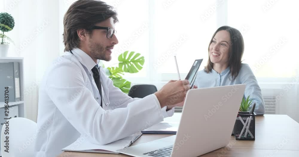 Woman patient taking doctor advice on xray report and leaving the clinic Woman patient taking doctor advice on xray report and leaving the clinic
