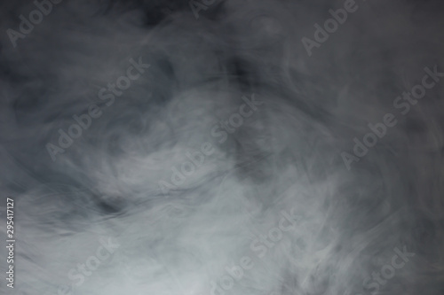 Smoke and fog in front of black background as a texture