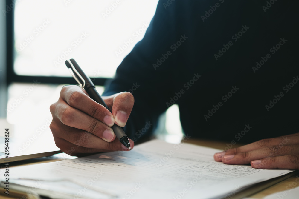 Business man signing a document to agree on financial planning after complete agreement plan in meeting room, investment concept, success concept Business man signing a document to agree on financial planning after complete agreement plan in meeting room, investment concept, success concept