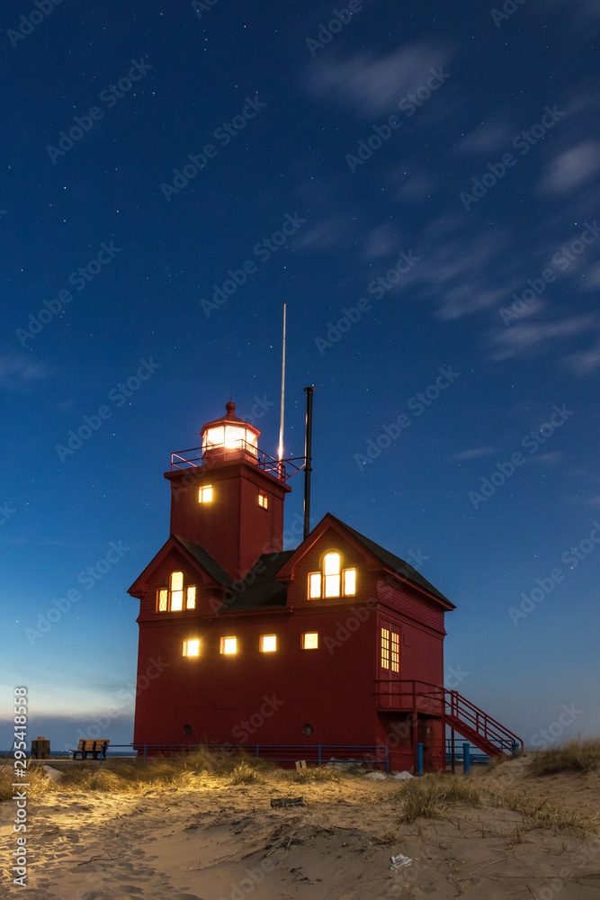 lighthouse at night with stars