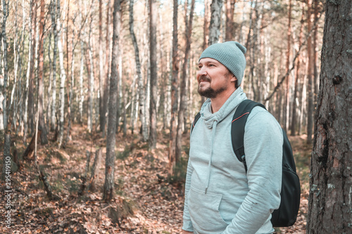 Hiker - man hiking in forest. Male hiker looking to the side walking in forest. Caucasian male model outdoors in nature. tinted image
