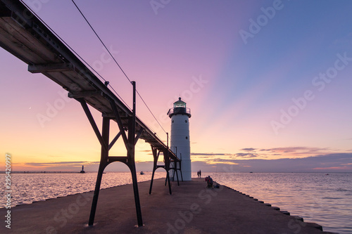 lighthouse at sunset with rays