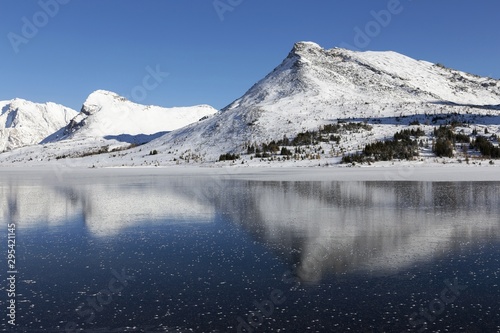 Reflection of Snowy Mountain Peaks in Frozen Lake Ice, Banff National Park Sunny Winter Day Landscape Canadian Rockies Alberta Canada