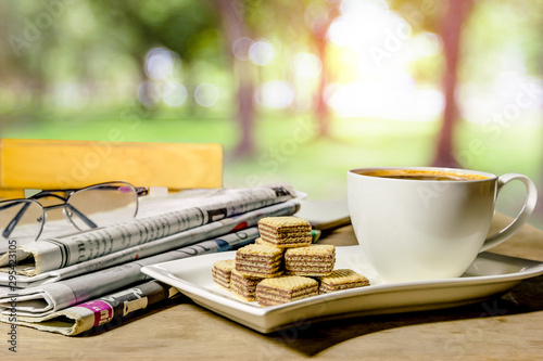 coffee and newspaper with nature background photo