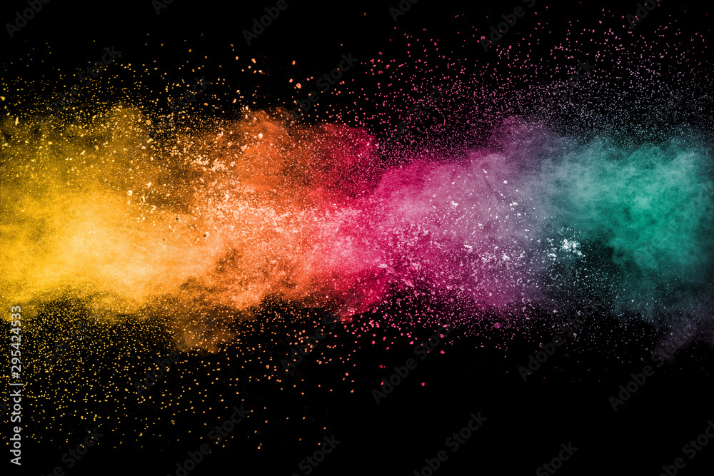 Colorful background of pastel powder explosion.Rainbow color dust splash on black background.