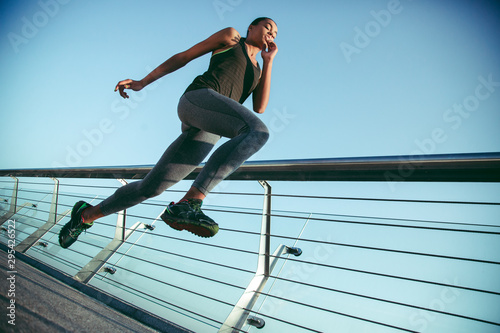 Young athlete jumping high outdoors stock photo