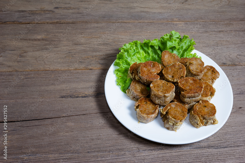 Deep Fried Crab meat roll or Hoi jo on wood background Deep Fried Crab meat roll or Hoi jo on wood background