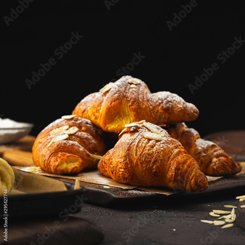 Fototapet Breakfast croissant with chocolate on a dark stone background