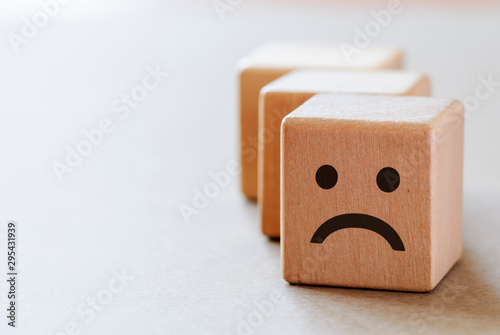 Sad wooden dices with unhappy face photo
