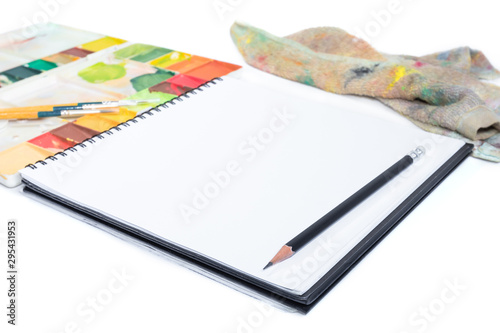 closeup open note book with tray colors on background