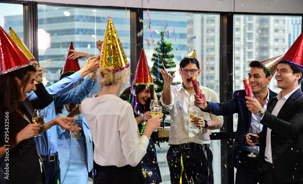 Business men and women with glasses of champagne celebrating Christmas and New Year for success in Business at the Office