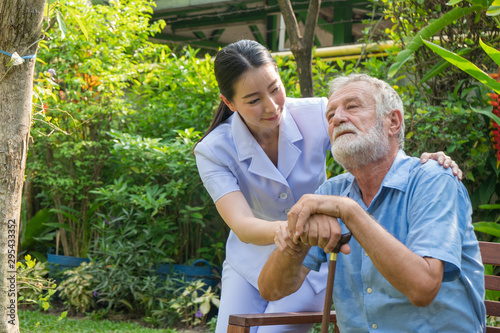 Young nurse take care senior man at home, Senior man happniess and smiling with nurse, Health care concept photo