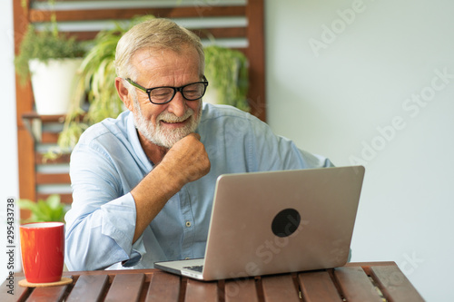 Portrait senior man using laptop for working at home, Freelance concept - Image