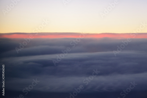 The blue skyline with cloudy in sunrise time, view from window on the plane.
