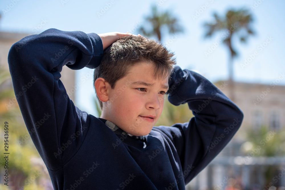 skeptical teenager with hands on his head 