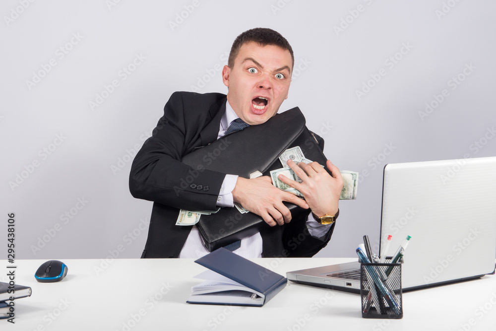 Businessman with a briefcase full of money in the hands Businessman with a briefcase full of money in the hands