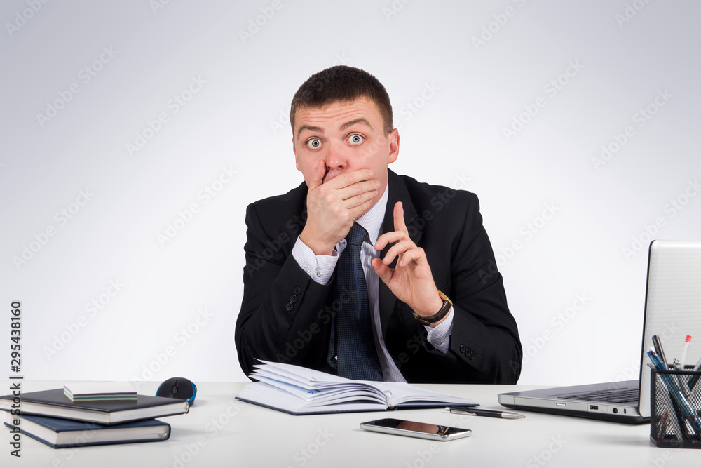 Office, finances, internet, business, success and people concept-Businessman with smartphone holding his finger in front of his mouth and making silence gesture shh Office, finances, internet, business, success and people concept-Businessman with smartphone holding his finger in front of his mouth and making silence gesture shh