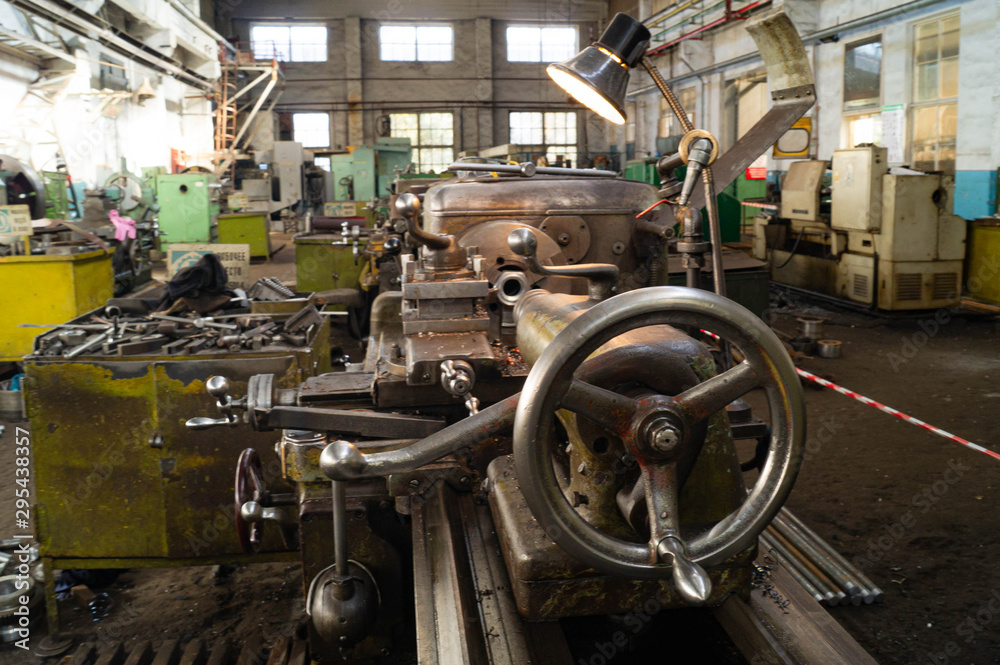 Fototapeta premium Metalworking workshop, metal processing machines. Levers of control of the machine.