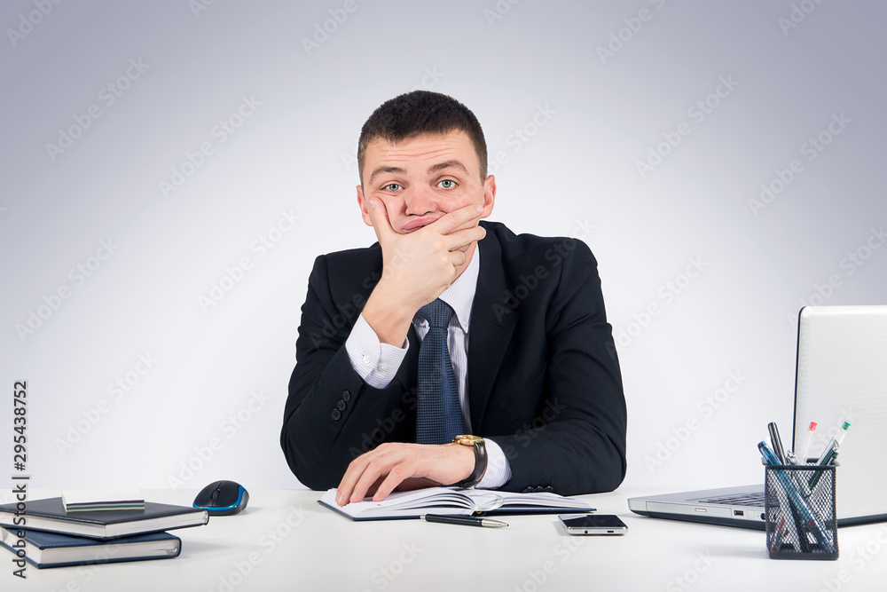 Business,office, technology, finances and internet concept - Serious businessman skeptically looking at you sitting at his desk.Human face expression Business,office, technology, finances and internet concept - Serious businessman skeptically looking at you sitting at his desk.Human face expression