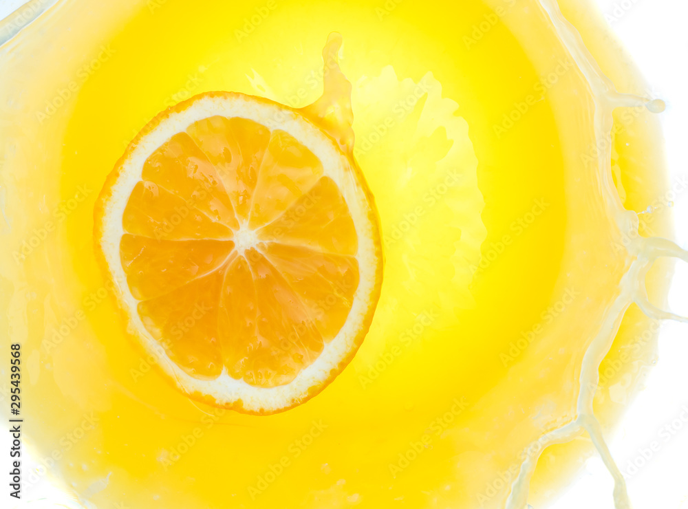 a piece of orange will fall into juice and spray, top view