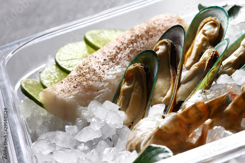 oysters in ice with lemon, salmon and shrimps photo