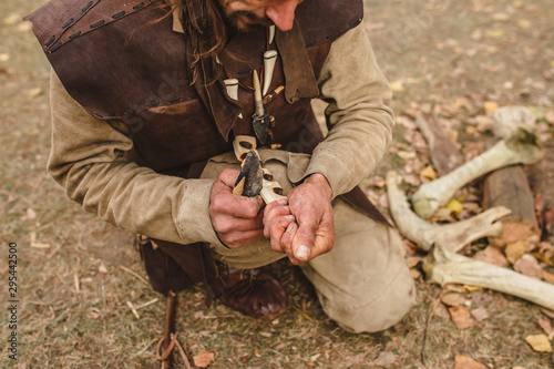 How to make fire by friction using a bow with leather cord, a soft wood for ignition and a solid wood for emphasis and drill or sprindle