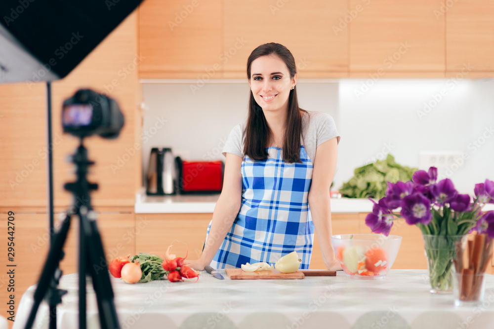 Female Food Vlogger Filming a Cooking Video in her Kitchen Female Food Vlogger Filming a Cooking Video in her Kitchen