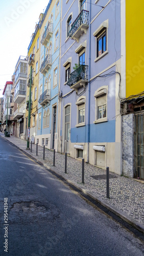  Typical street with coloured buildings with tiles (azuleios) wall of Lisbon, Portugal