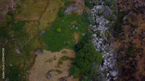 Wallpaper Mural Aerial, tilt up, drone shot, over rocks and trees, in Vale Glaciar valley, revealing the Manteigas village, on a sunny day, in Serra da estrela natural park, in Portugal Torontodigital.ca