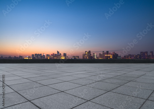 Panoramic skyline and buildings with empty square floor at dusk