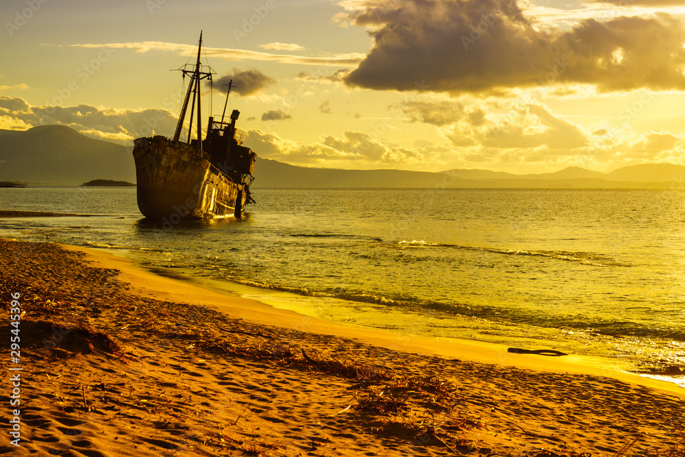 Rusty broken shipwreck on sea shore Rusty broken shipwreck on sea shore