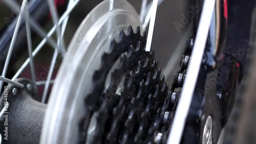 masters, lubricate the bicycle chain of a mountain bike with a special lubricant in the home workshop. Cleaning and lubricating the bicycle chain and gearbox with oil spray close up selective focus