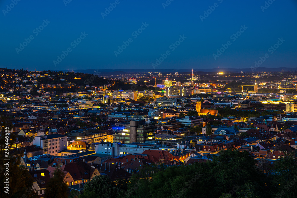 Germany, Illuminated magical skyline of downtown stuttgart city houses, buildings and churches seen from above by night after sunset