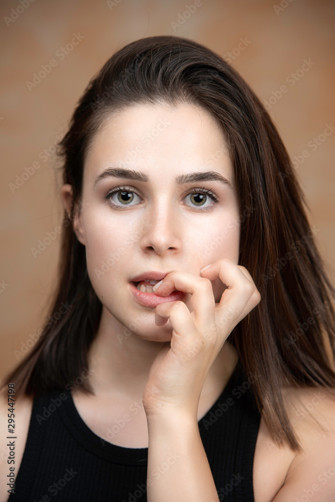 Young girl with nervous face expression biting fingernails portrait Young girl with nervous face expression biting fingernails portrait