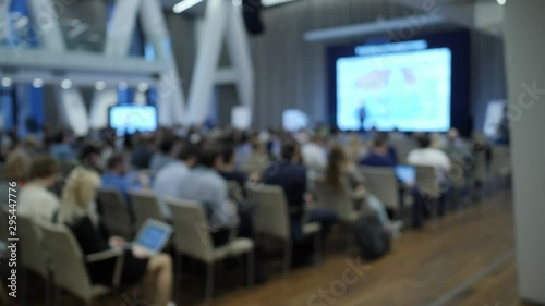 Wallpaper Mural People seat in front of screen. Lecture in a modern space. Unfocused scene Torontodigital.ca