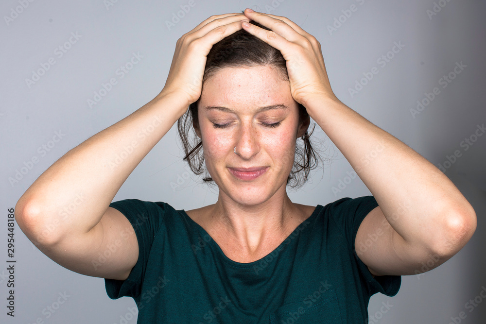 Stressed woman keeping hands on head portrait Stressed woman keeping hands on head portrait