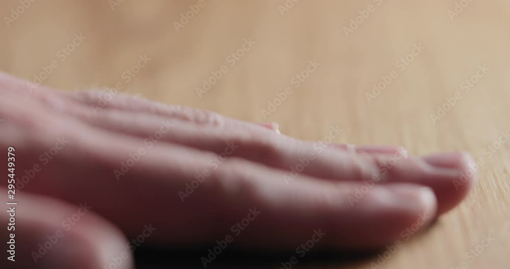 Slow motion man hand touch oil finished oak wood surface Slow motion man hand touch oil finished oak wood surface