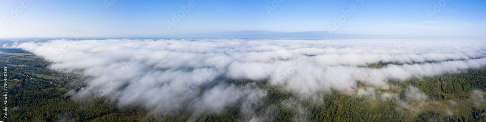 Beautiful hight way road high angle beautiful view of the fog over the road on an early summer morning in central Russia. Bird's eye view of the road and skyline.