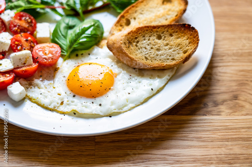 Breakfast - fried egg  toasts and vegetable salad