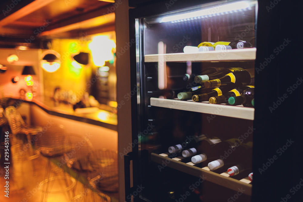 Storing bottles of wine in fridge. Alcoholic card in restaurant