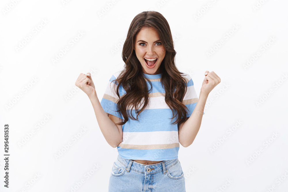 Upbeat excited good-looking woman hear excellent news feel lucky and ambitious aim to win, clench hands, fist pump and shouting yes hooray, playing casino amused, white background Upbeat excited good-looking woman hear excellent news feel lucky and ambitious aim to win, clench hands, fist pump and shouting yes hooray, playing casino amused, white background
