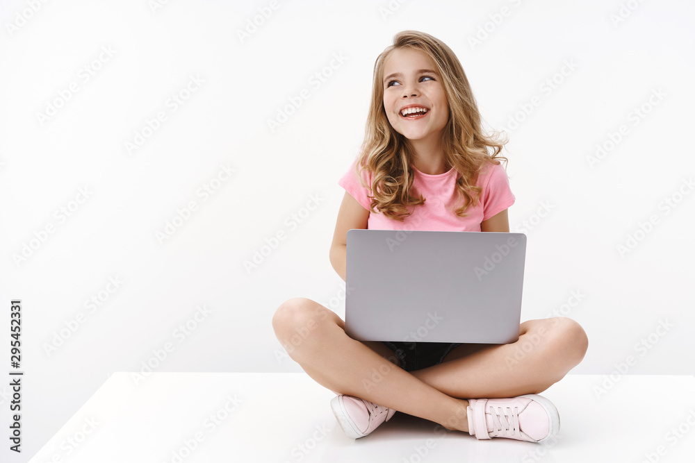 Carefree cheerful blond caucasian cute kid young sister sitting floor with laptop, laughing joyfully, studying online, digital education, look away left copyspace, smiling happy, learn new language Carefree cheerful blond caucasian cute kid young sister sitting floor with laptop, laughing joyfully, studying online, digital education, look away left copyspace, smiling happy, learn new language
