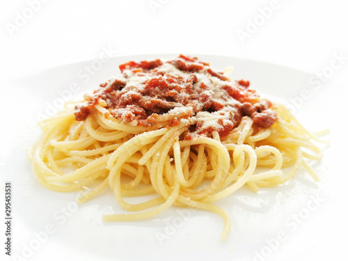 Spaghetti Bolognese with minced beef, onion, chopped tomato, garlic, olive oil, stock cube, tomato puree and Italian herb. Traditional Italian food in a white plate.