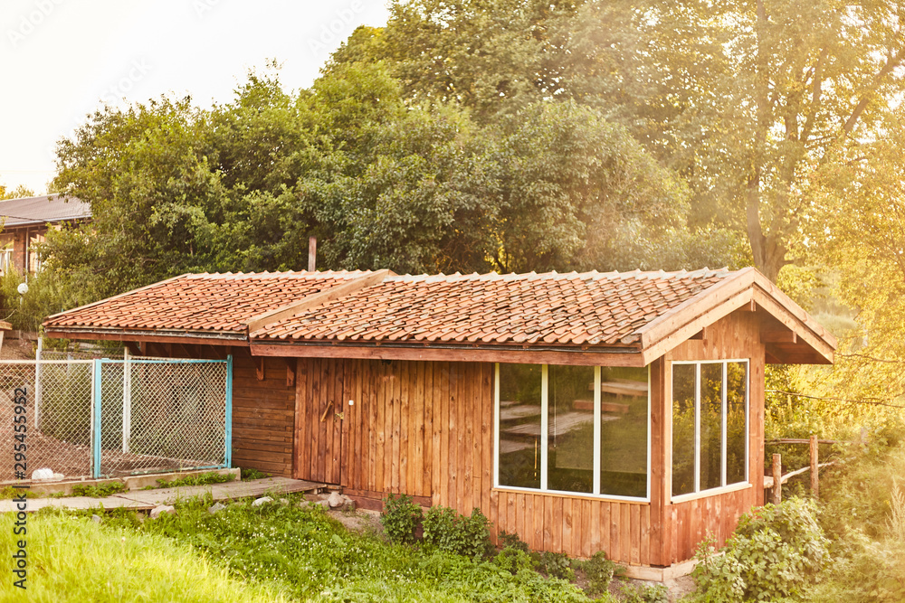 Fototapeta premium wooden extension in the bathhouse. Tiled Roof Wooden House