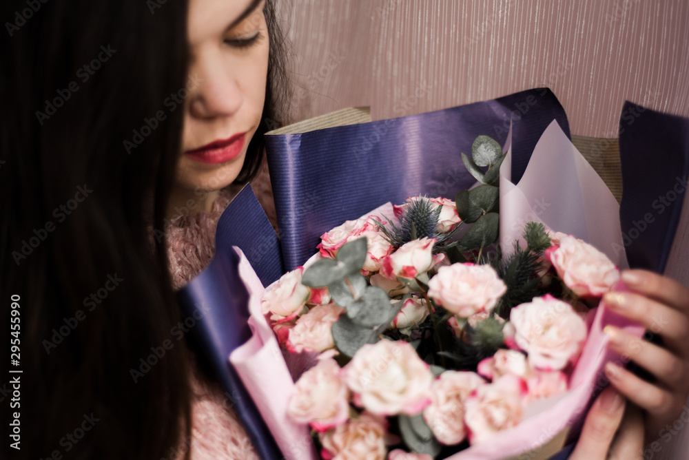 beautiful brunette with a bouquet of roses beautiful brunette with a bouquet of roses