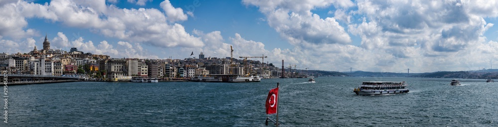 Istanbul, Turkey: the breathtaking skyline with the Galata Tower and a ship crossing the Bosphorus for a cruise in the Strait of Istanbul, part of the continental boundary between Europe and Asia