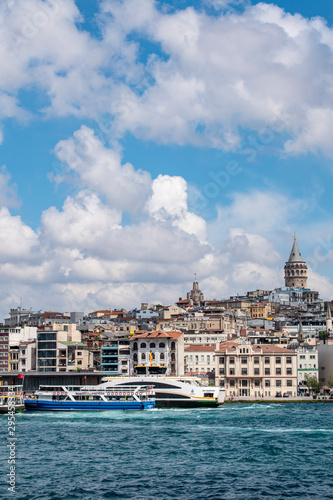 Istanbul, Turkey: the breathtaking skyline with the Galata Tower and a ship crossing the Bosphorus for a cruise in the Strait of Istanbul, part of the continental boundary between Europe and Asia © Naeblys