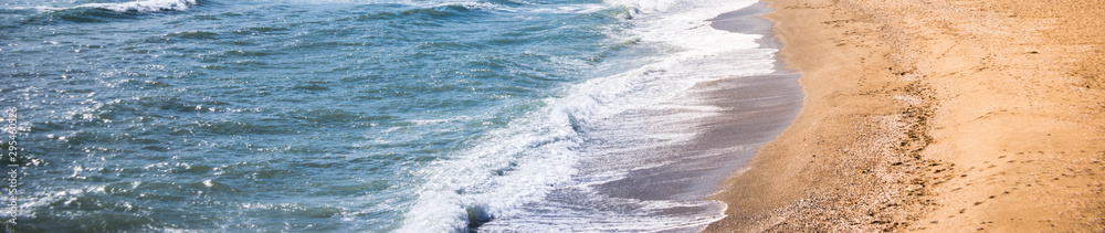 Close up of the sea water affecting the sand on the beach, sea waves calmly flowing sand, relaxing view Close up of the sea water affecting the sand on the beach, sea waves calmly flowing sand, relaxing view