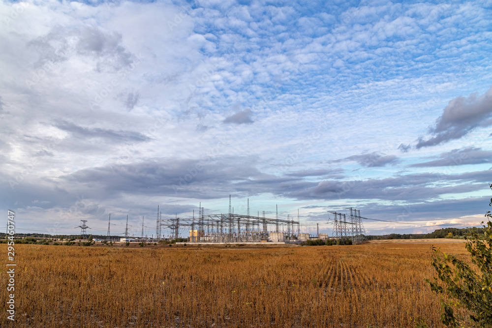 Electrical sub station against the cloudy sky. Energy generation landscape. Electrical sub station against the cloudy sky. Energy generation landscape.