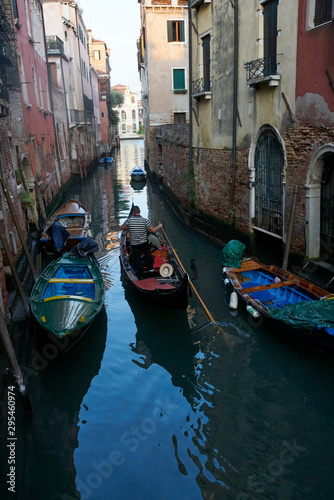 Venice / Italy - September 29th 2019: Gondolier rowing a gondola in Grand Canal